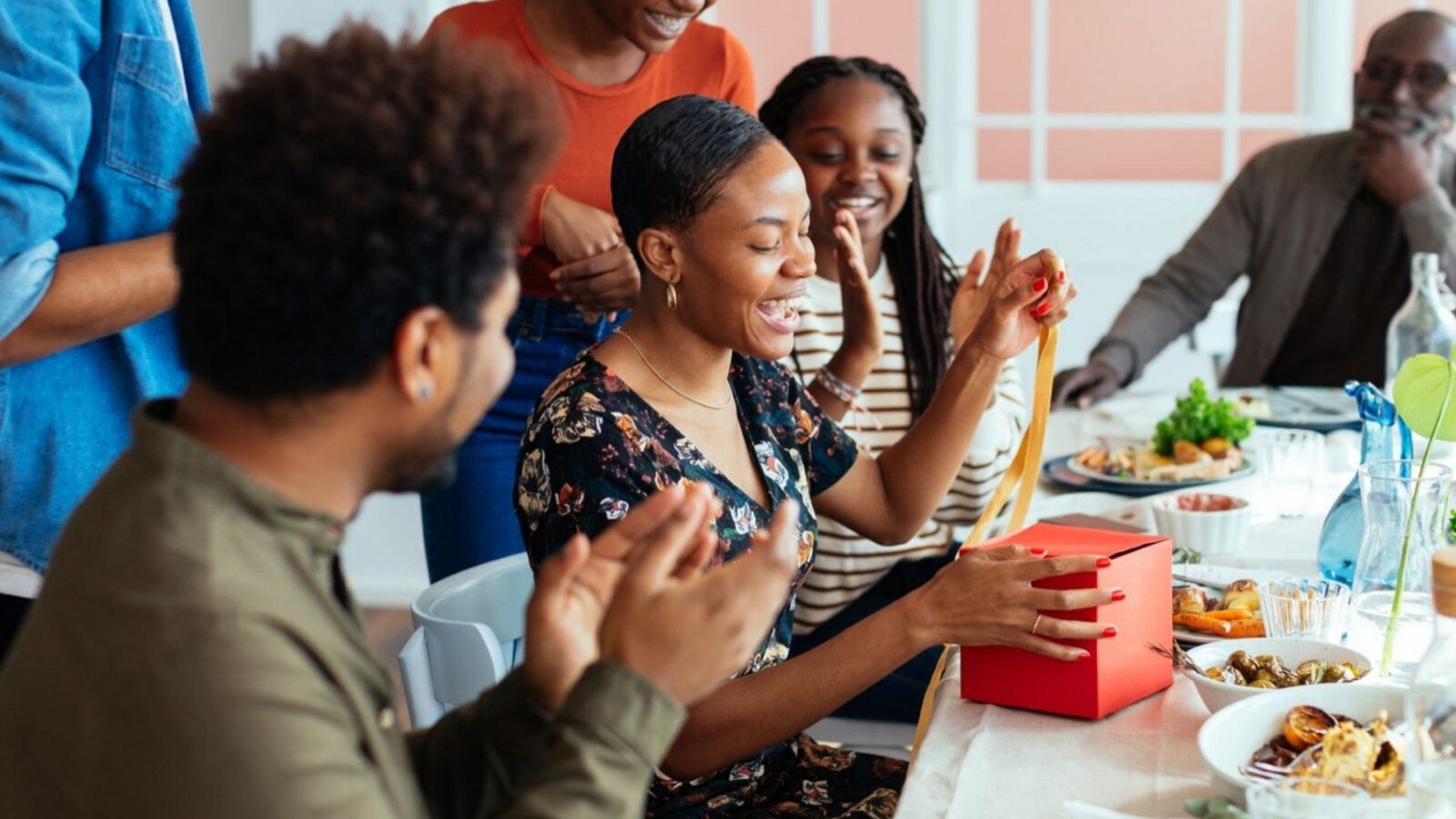 People opening gifts and thinking about giving to charity