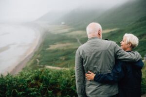 older couple overlooking ocean and green